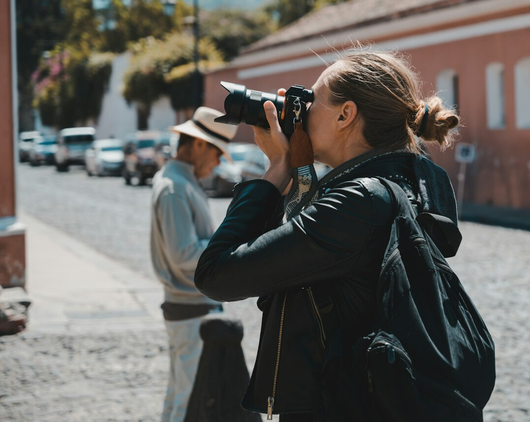 Photographer taking a portrait of a woman outdoors